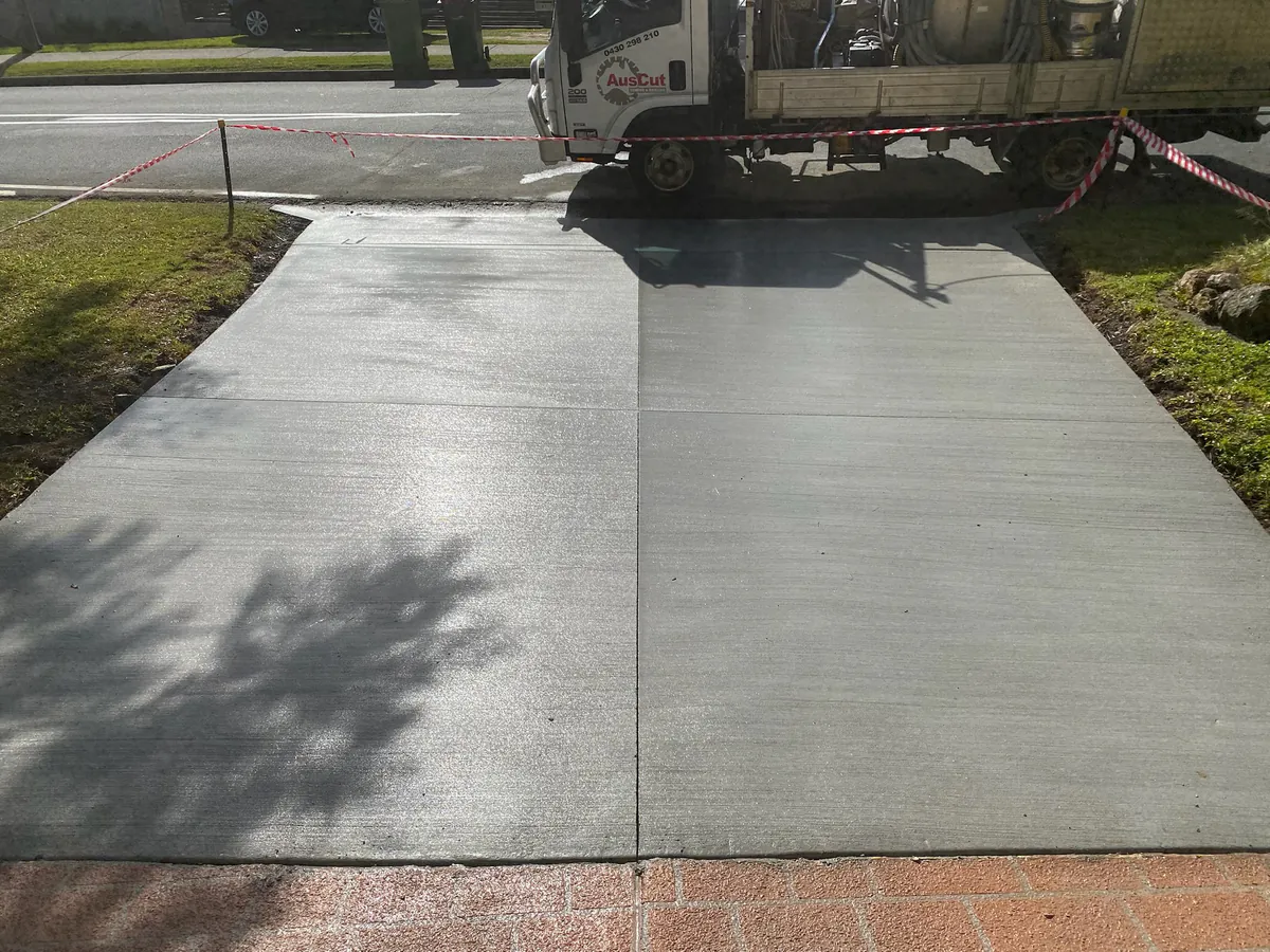 Soft cut control joint down the centre of a fresh driveway pour
